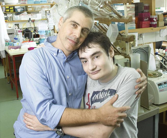 Dr. Miguel Weil, left, is researching a cure for familial dysautonomia, which his son Nir was diagnosed with 25 years ago.